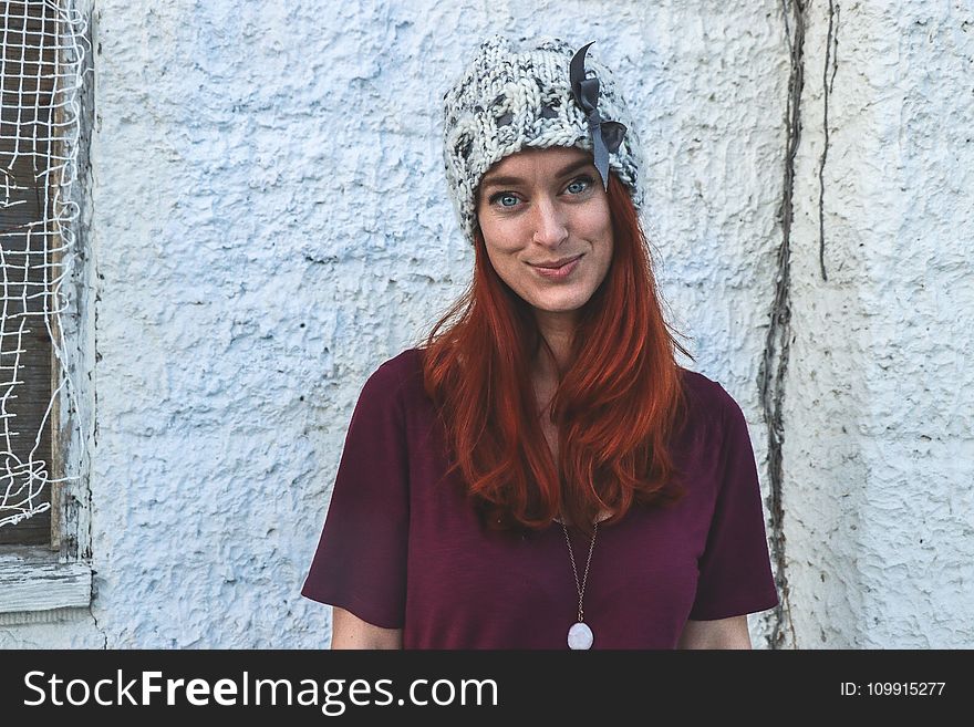 Photo of Woman in Maroon Top and Knitcap