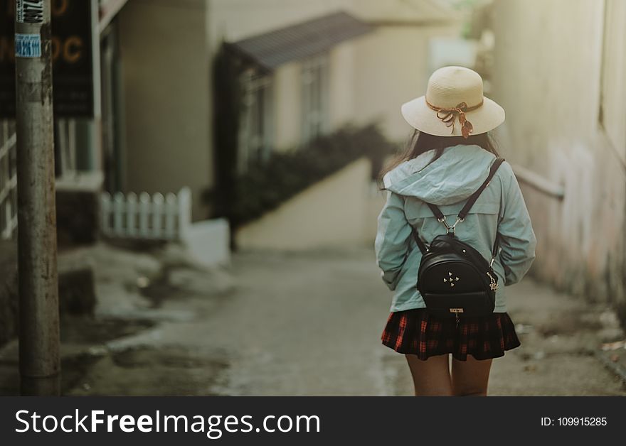 Girl in Blue Jacket and Black Leather Knapsack Walking on Street
