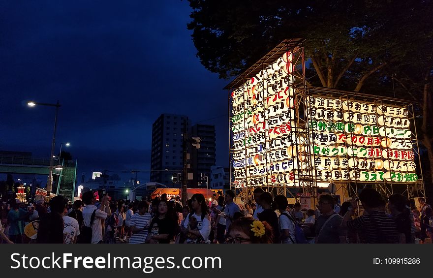 Group Of People Near Multicolored Lantern Display