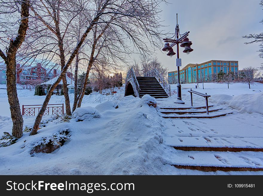 Bridge Near Light Post With Snow and Building at Distance