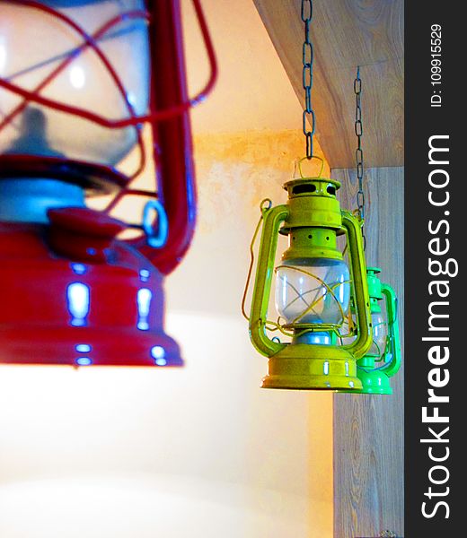 Three Red, Yellow, And Green Gas Lantern Hanging On Ceiling