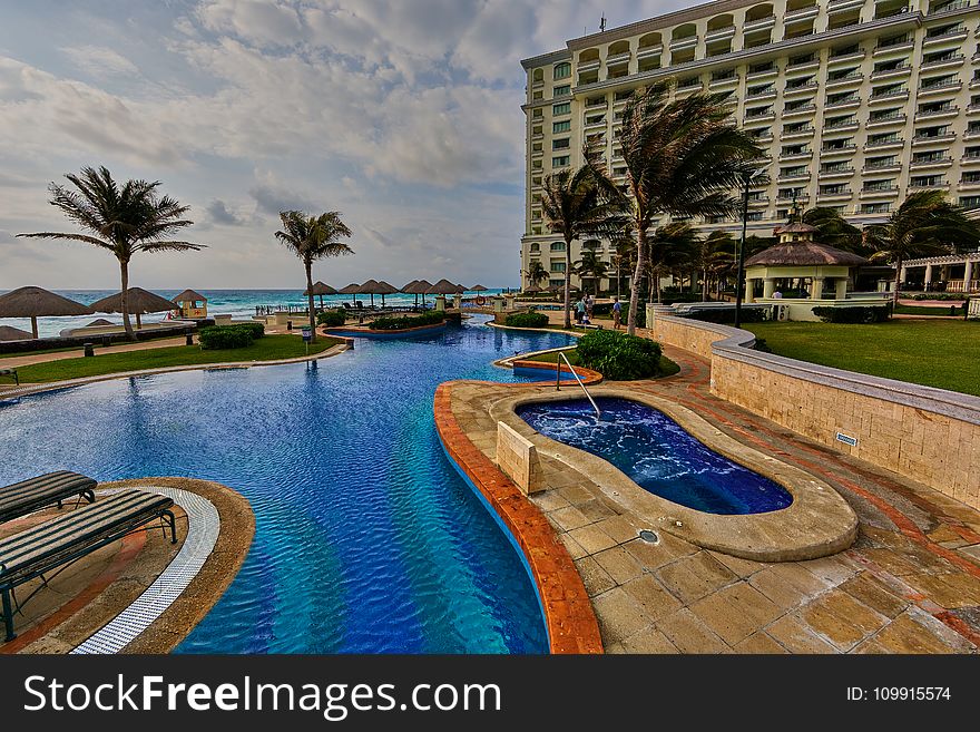 In-ground Pool Near Building During Daytime