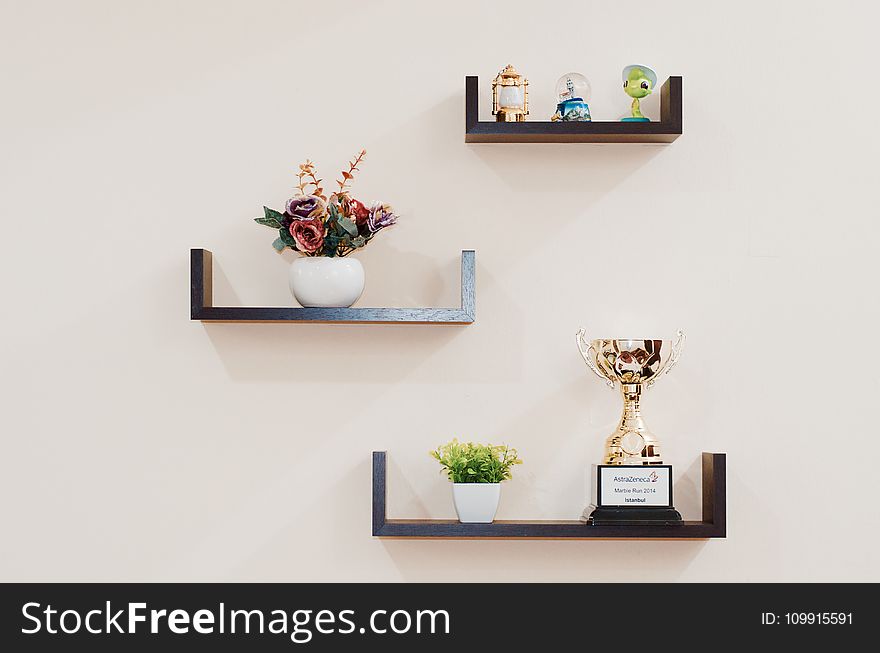 Brown Wooden Floating Shelves Mounted on Beige Painted Wall