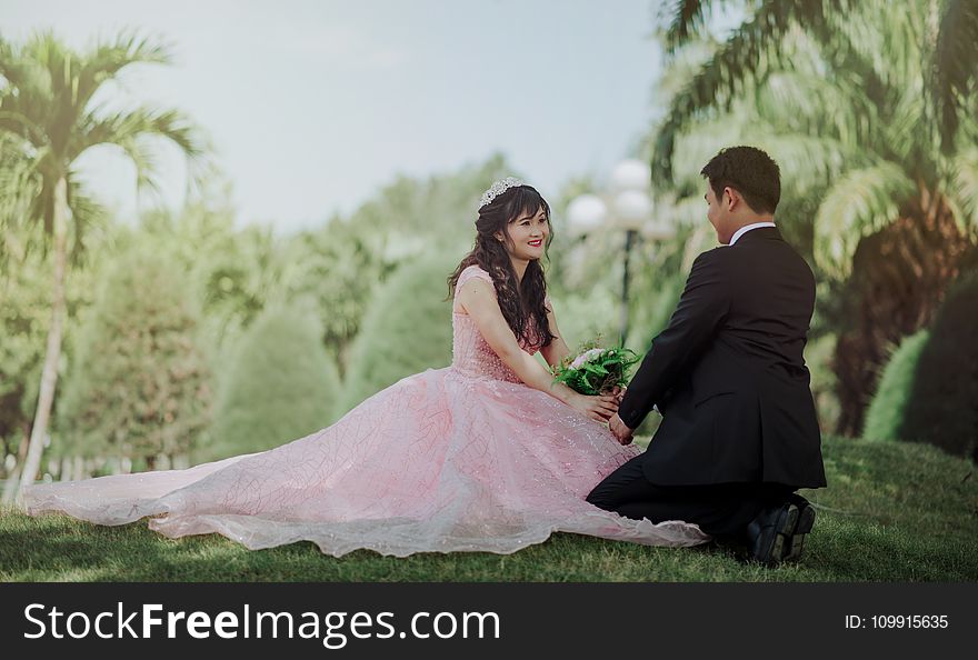 Couple Sitting On Grass