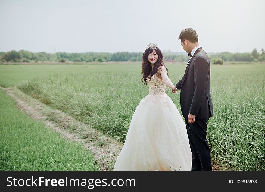 Groom and Bridge Along Hallway at Daytime