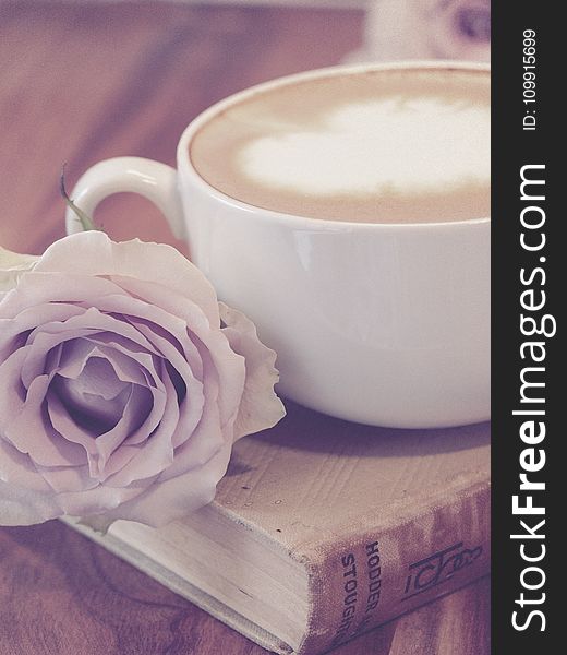 Photography of Flower Beside Coffee on Top of Book