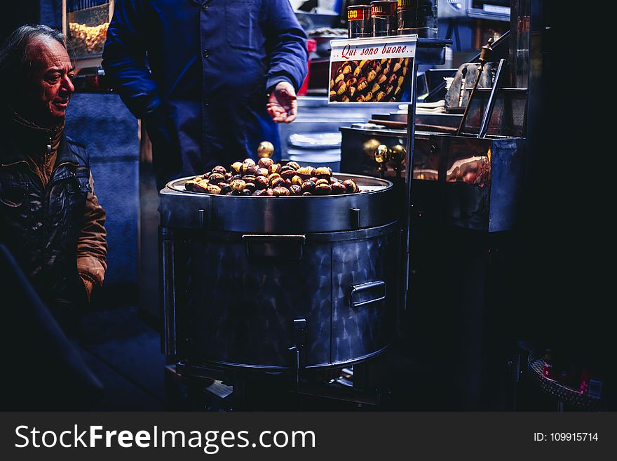 Man Sitting and Looking on Chestnuts