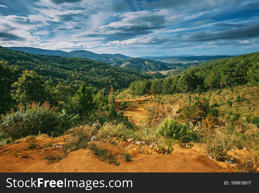 Scenic View Of Mountains Under Cloudy Sky