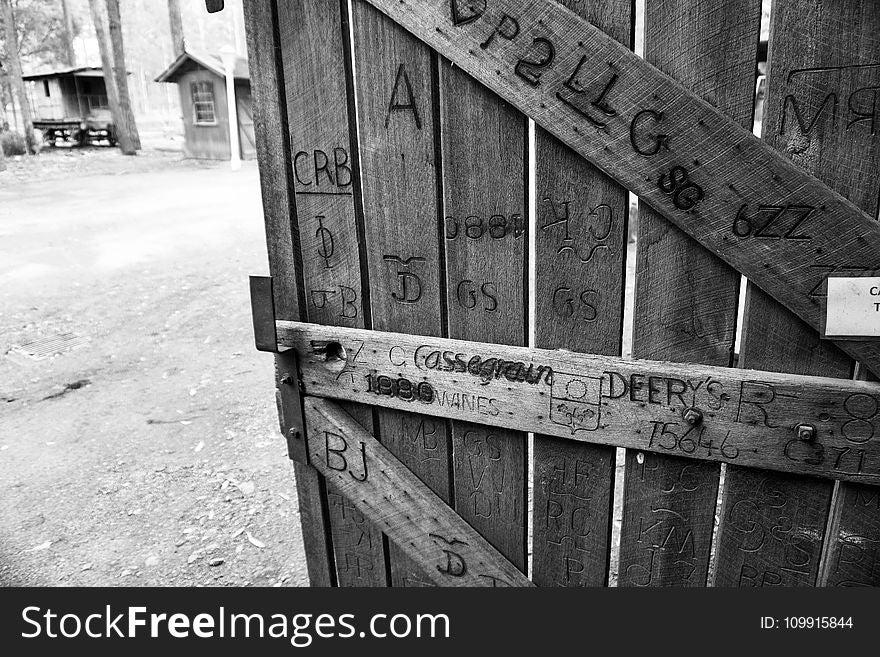 Gray Scale Photo of Brown Wooden Gate