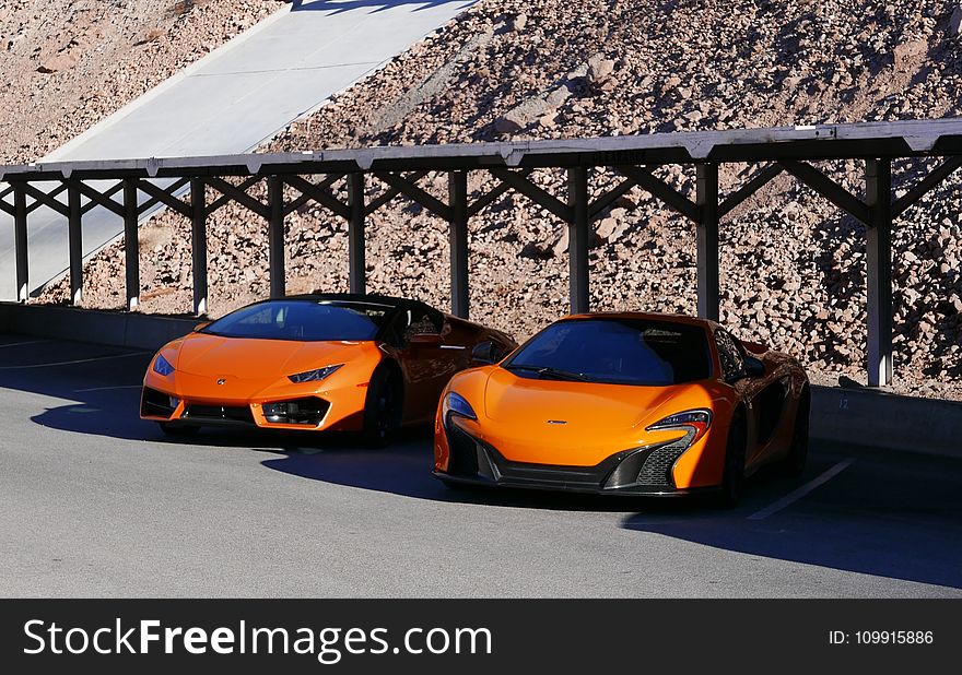 Photography of Two Orange Sports Car
