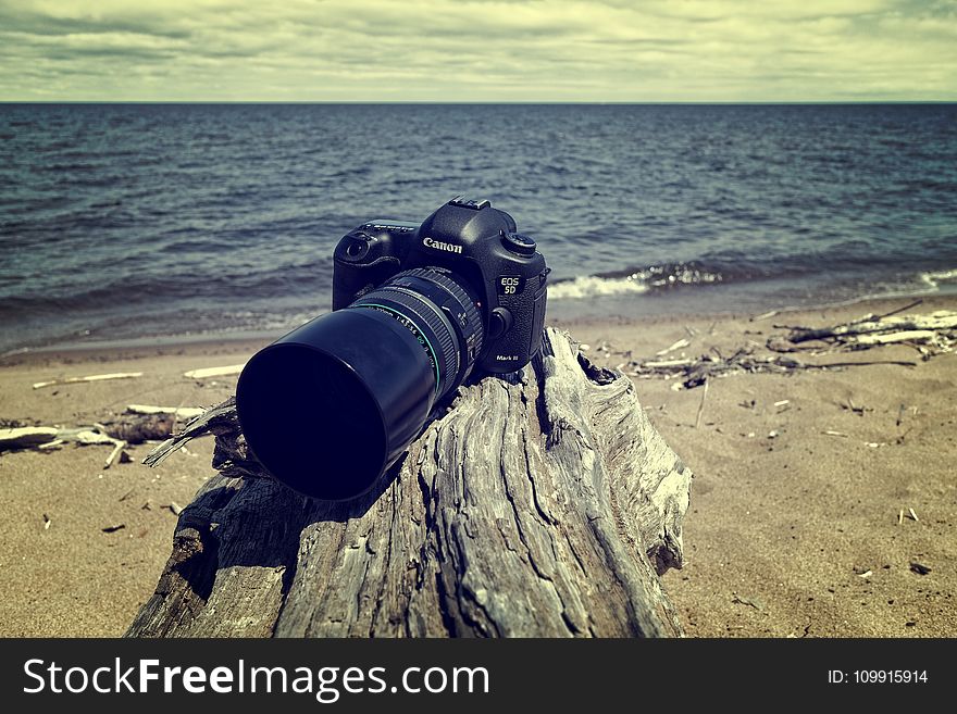 Black Canon Dslr Camera Near Sea Shore