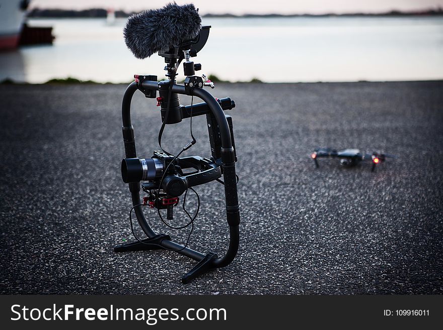 Shallow Focus Photography of Black Quadcopter Near Body of Water