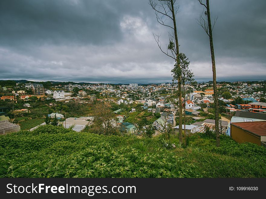 Scenic View of City Under Cloudy Sky