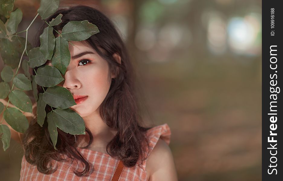 Woman Wearing Pink Sleeveless Top Behind Leaves