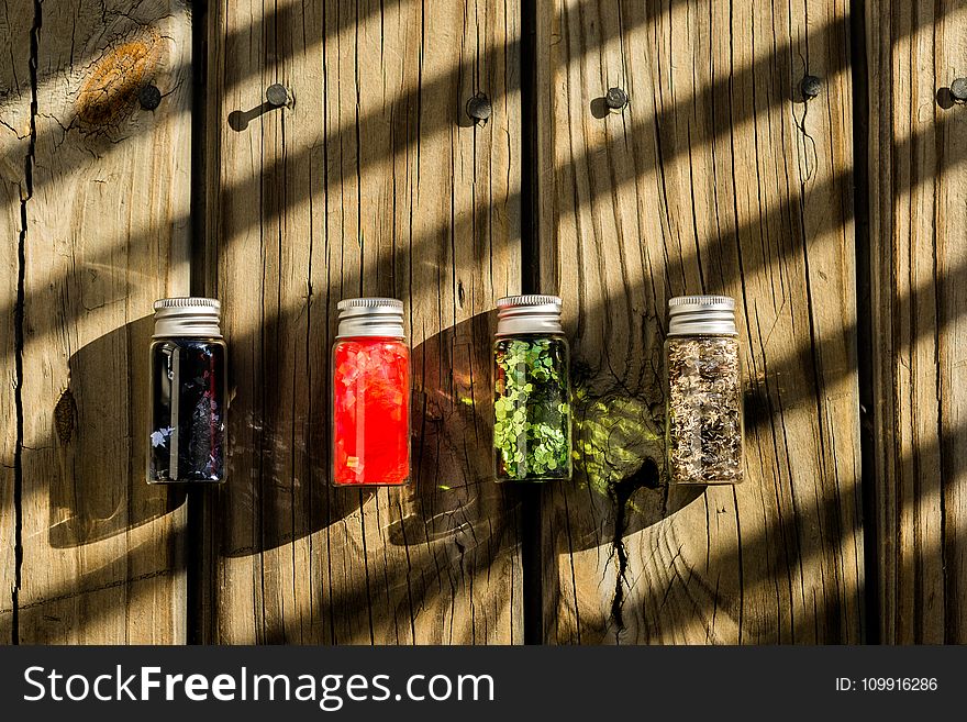 Several Assorted-color Glass Bottles on Table