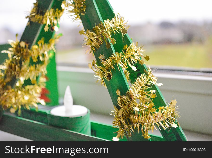 Shallow Focus Photography Of Green And Yellow Candle Holder With White Candle