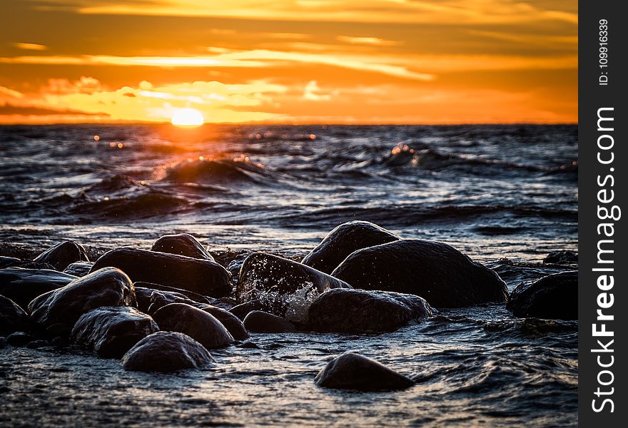 Stones on Beach during Sunset
