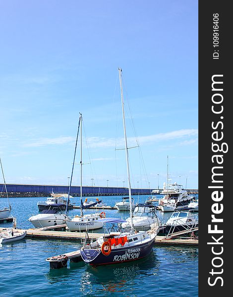 White and Black Robinson Yacht Beside Dock