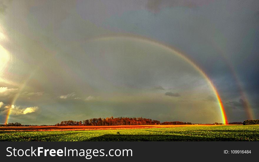 Photography of Green Grass Field With Rainbow