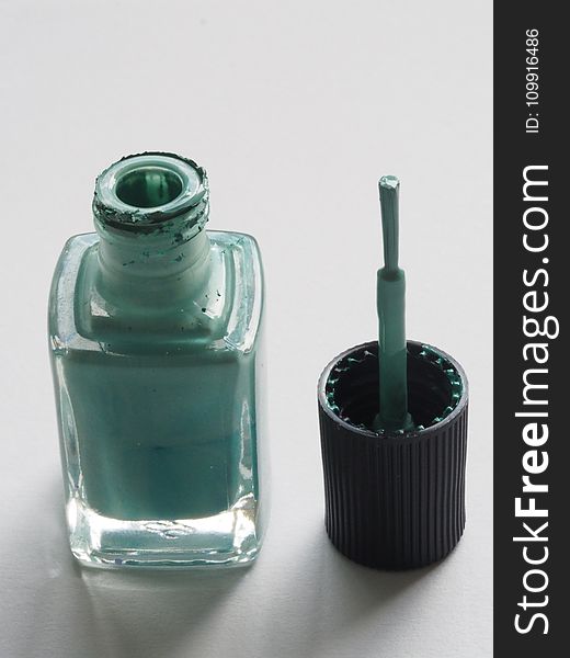 Shallow Focus Photography of Teal Nail Lacquer