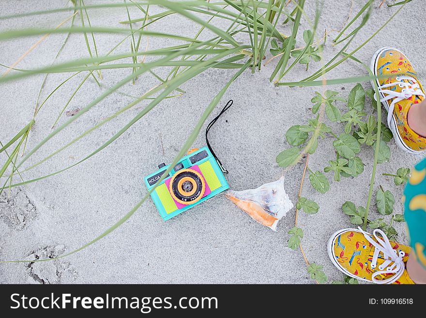 Multicolored Digital Camera With Pair Brown Shoes