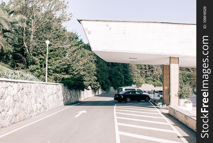 Black Car Parked On Gray Pavement