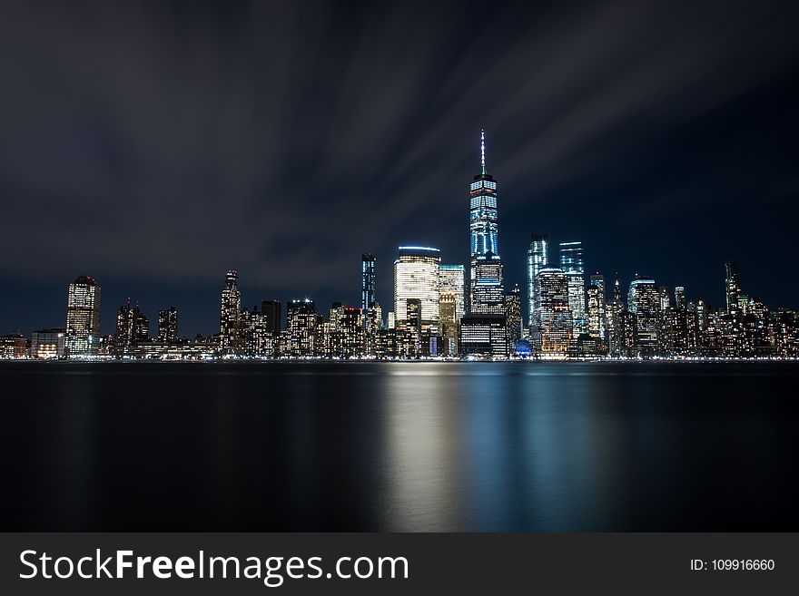 High-rise Buildings at Night Near Sea