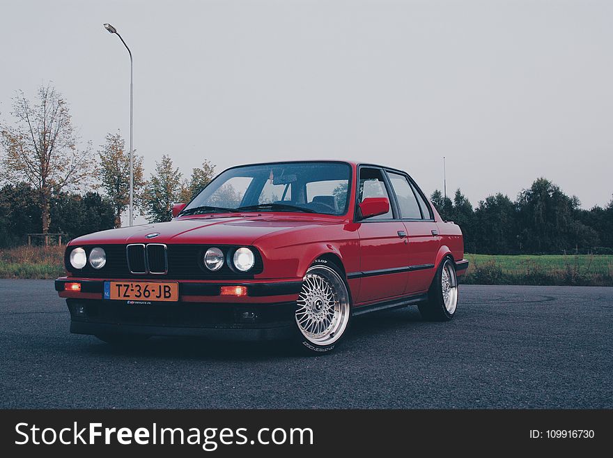 Photography of Red BMW On Asphalt Road