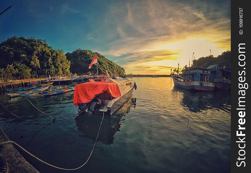 Motor Boat Near Dock During Sunset