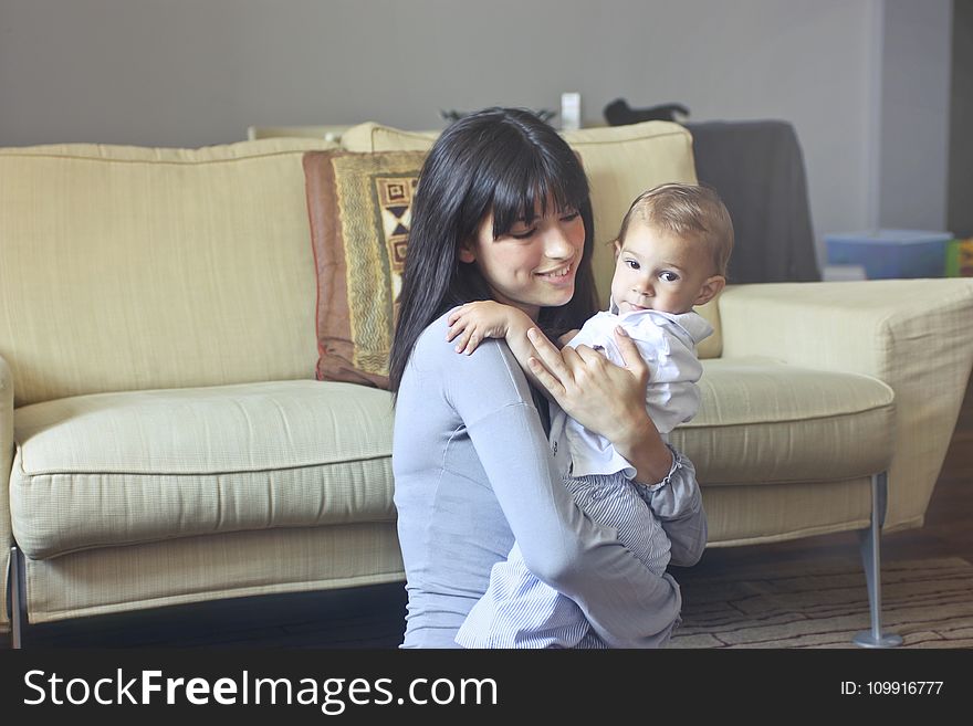 Woman In Gray Sweater Carrying Toddler In White Button-up Shirt