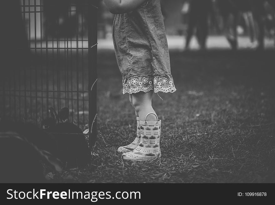 Monochrome Photography Of Children Wearing Boots