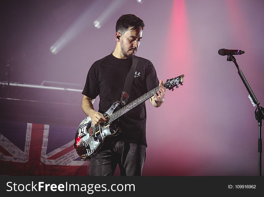 Man Wearing Black T-shirt And Playing Electric Guitar