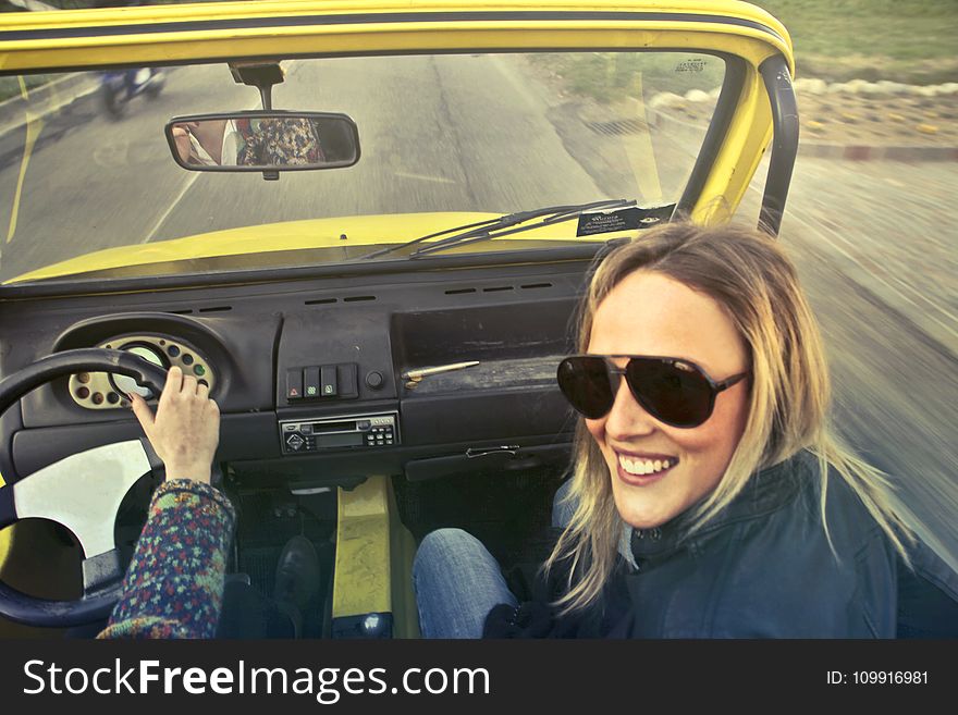 Woman In Black Aviator Sunglasses Sitting On Car&#x27;s Passenger Seat
