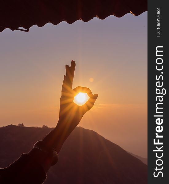 Photography of Hand During Sunset