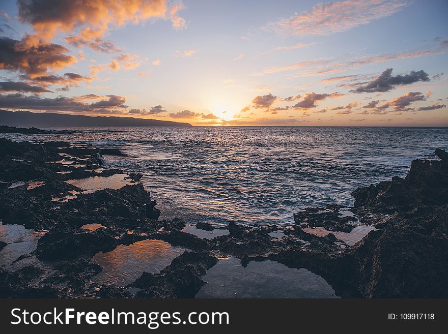 Scenic View Of Ocean During Sunset