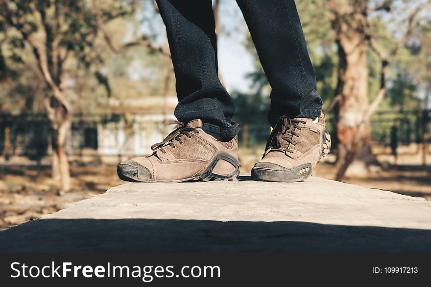 Selective Focus Photography of Person Wearing Brown Hiking Shoes