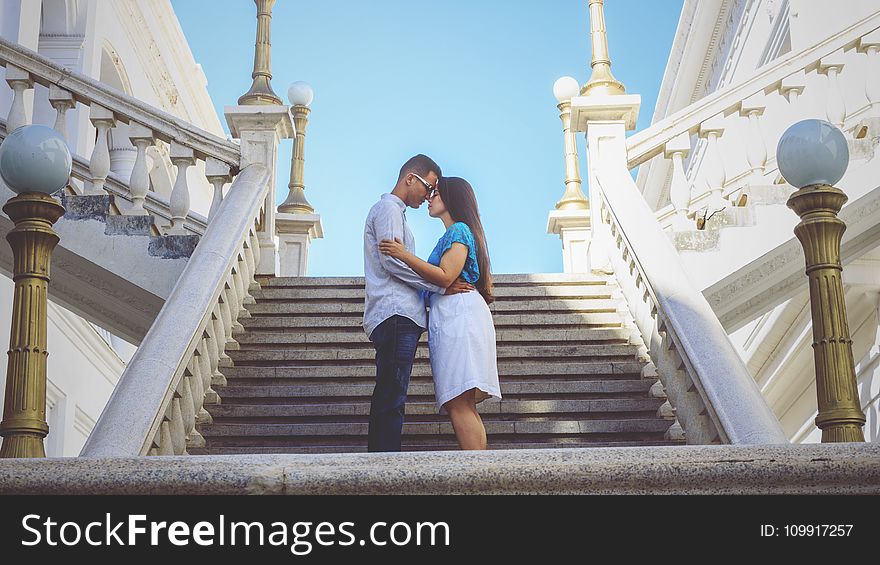 Couple Standing By The Stairs