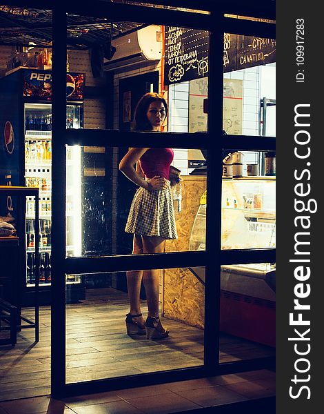 Photo of a Woman Standing in Front of the Counter