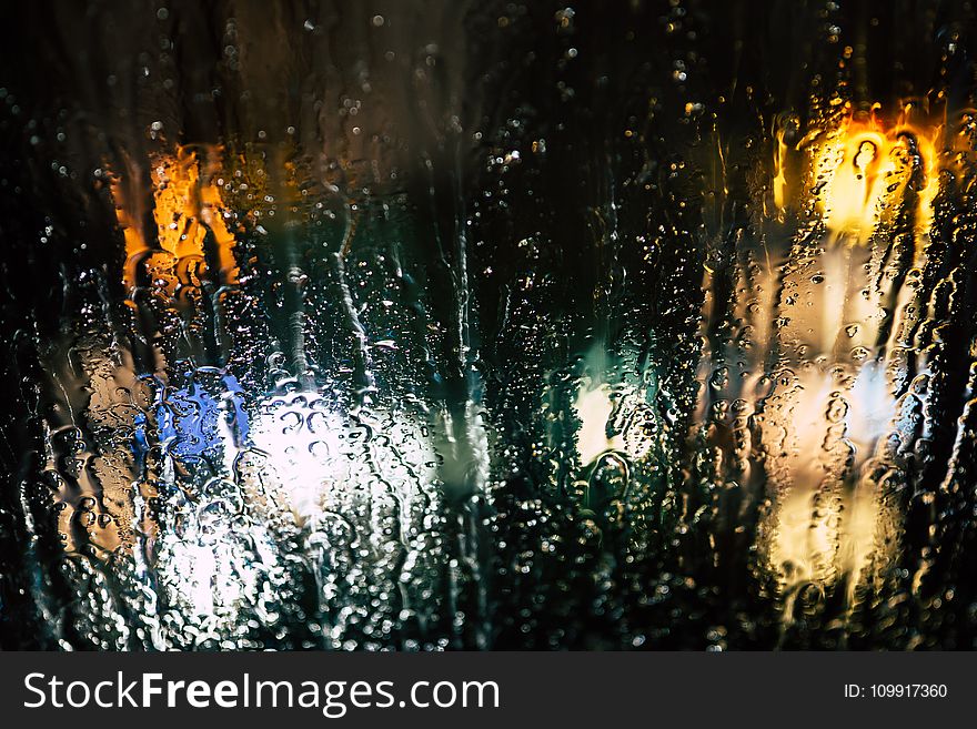 Selective Photography of Glass Window With Drops of Water during Nighttime