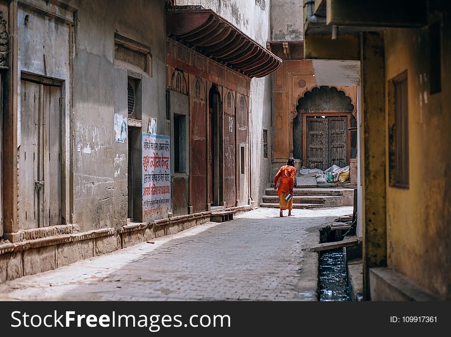 Person Standing Between Two Buildings