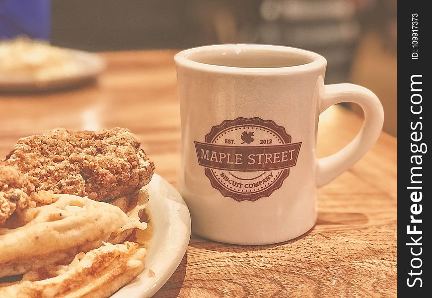 White and Brown Maple Street Ceramic Mug Beside Food