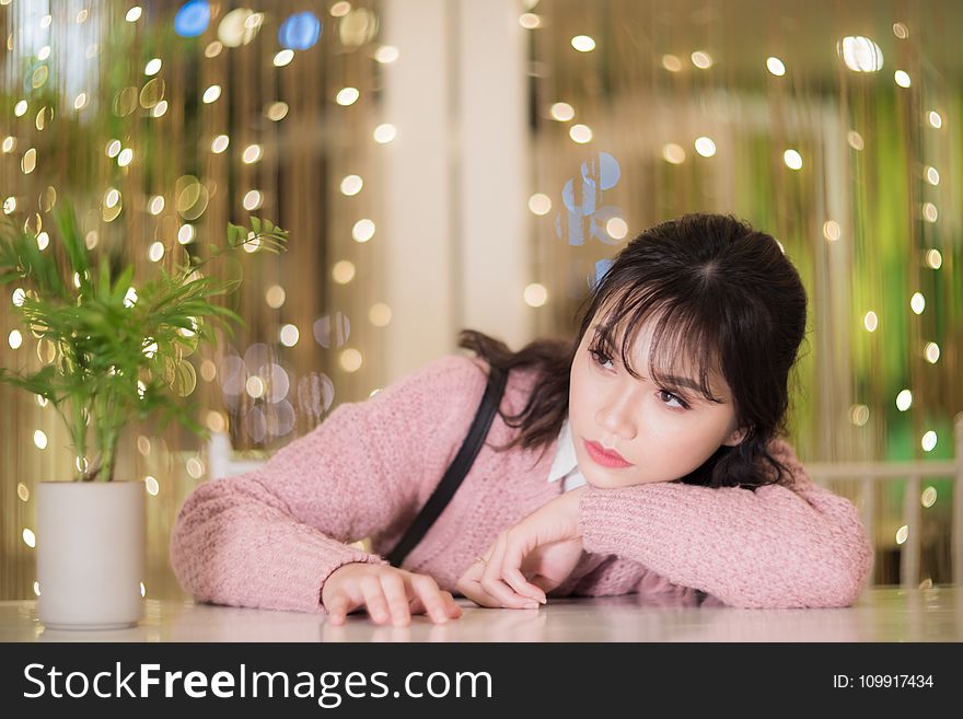 Woman With Her Hands On White Table