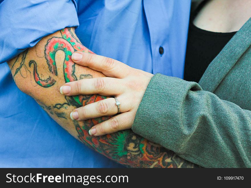 Man With Tattoo With a Woman in Green Top