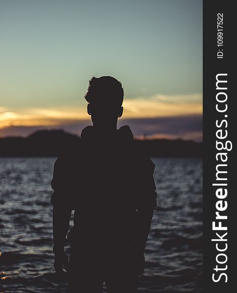 Silhouette Photo of Person Near Body of Water