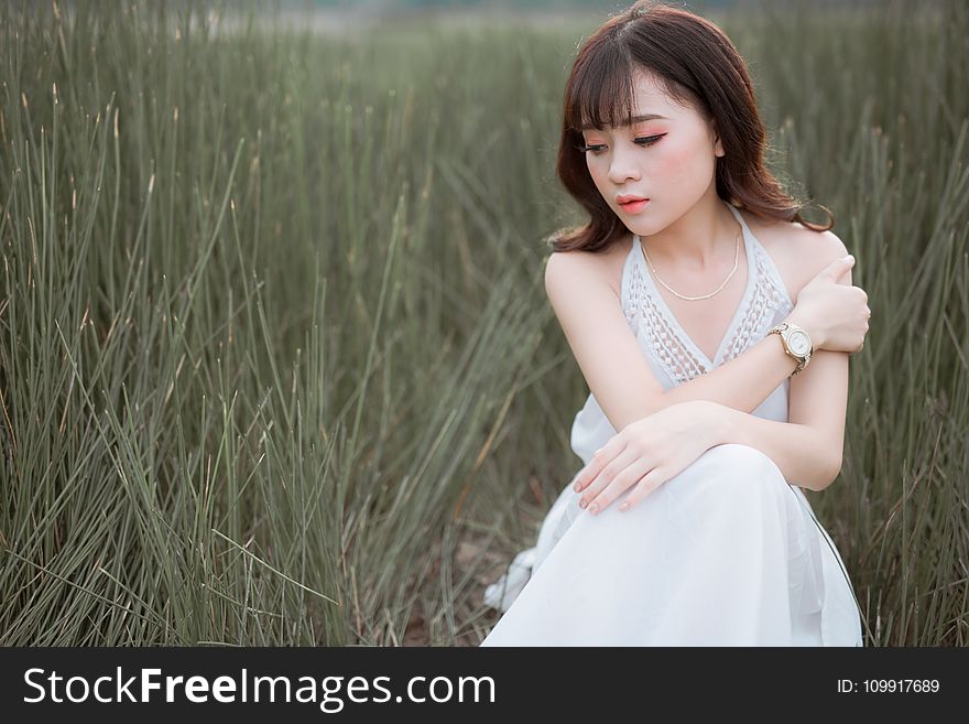 Woman Wearing White Halter Dress Surrounded By Grass