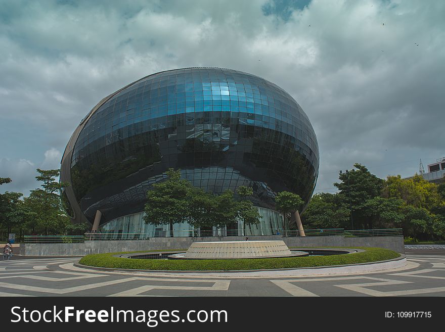 Blue Glass Building Near Green Trees