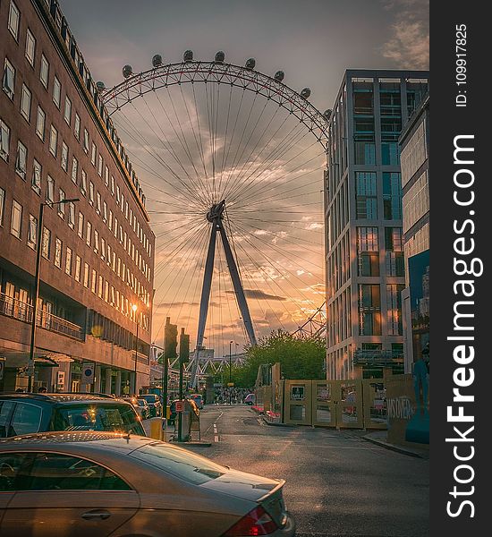 Ferris Wheel Near Building during Sunset