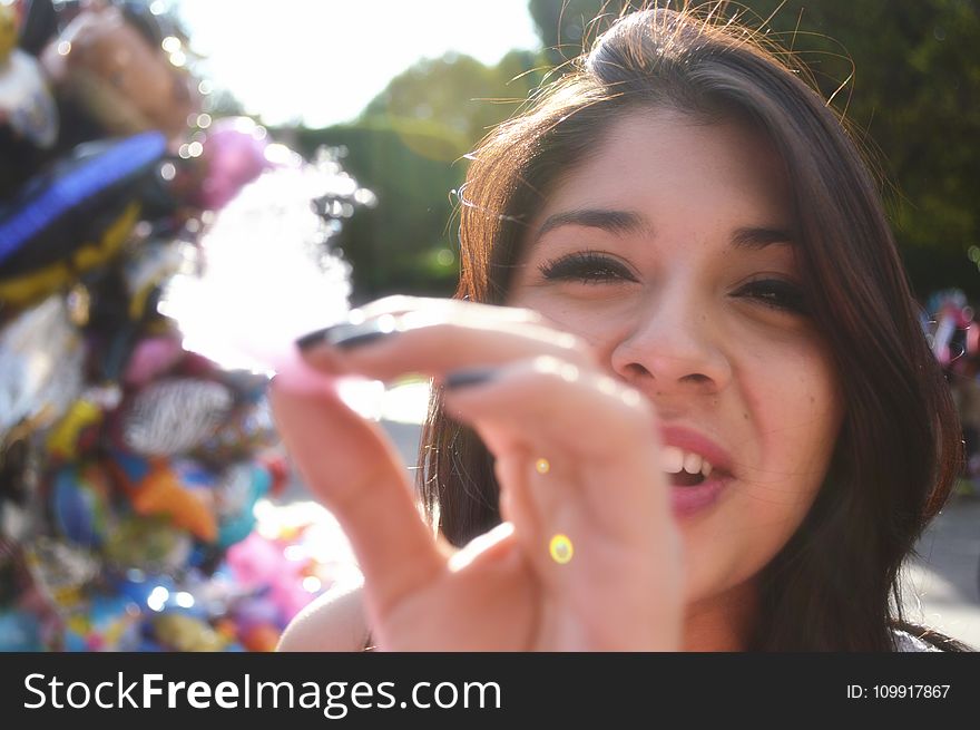 Woman Doing Holding Cotton Candy In Front Of The Camera