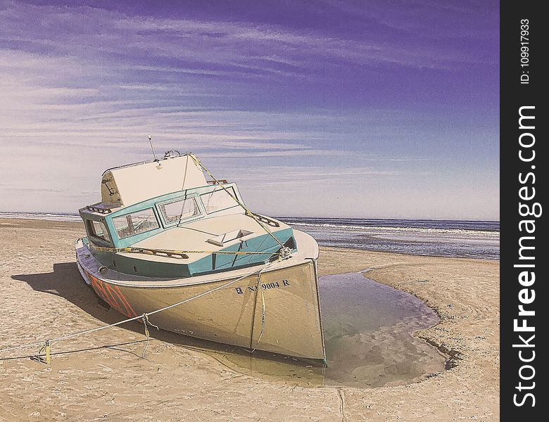 White and Teal Speedboat on Land