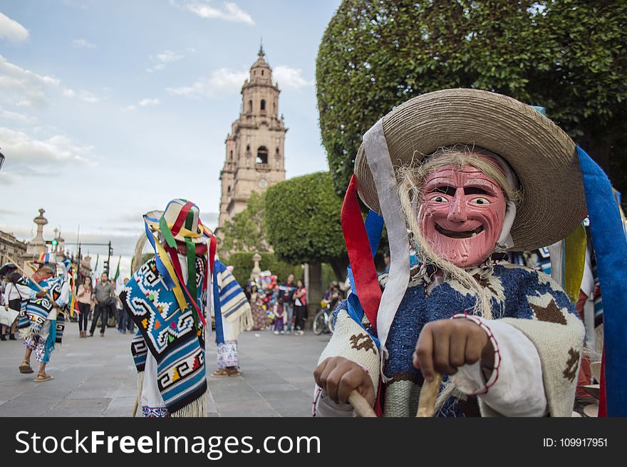 Person Wearing Blue And White Costume Taking Photo